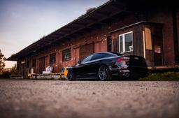 JR Wheels JR42 Grey alloy wheel mounted on car in an atmospheric setting