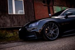 JR Wheels JR42 Grey alloy wheel mounted on car in an atmospheric setting