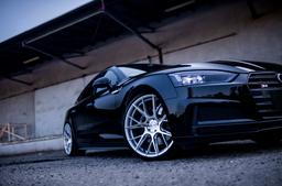 JR Wheels JR42 Silver alloy wheel mounted on car in an atmospheric setting