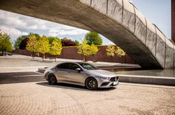 JR Wheels JR42 Black alloy wheel mounted on car in an atmospheric setting