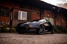 JR Wheels JR42 Grey alloy wheel mounted on car in an atmospheric setting