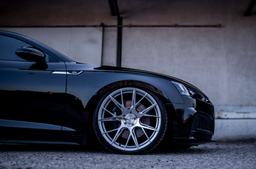 JR Wheels JR42 Silver alloy wheel mounted on car in an atmospheric setting