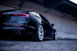 JR Wheels JR42 Silver alloy wheel mounted on car in an atmospheric setting