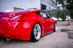 JR Wheels JR43 Silver alloy wheel mounted on car in an atmospheric setting