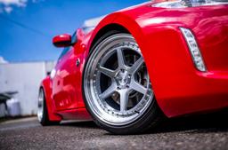 JR Wheels JR43 Silver alloy wheel mounted on car in an atmospheric setting