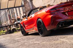 JR Wheels JR44 Black alloy wheel mounted on car in an atmospheric setting