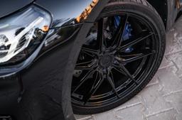 JR Wheels JR44 Svart aluminiumfälg monterade på bil i stämnigsfull miljö