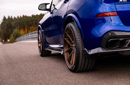 JR Wheels JR44 Bronze alloy wheel mounted on car in an atmospheric setting