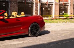 JR Wheels JR44 Black alloy wheel mounted on car in an atmospheric setting