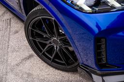 JR Wheels JR44 Black alloy wheel mounted on car in an atmospheric setting