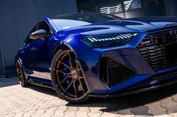 JR Wheels JR44 Bronze alloy wheel mounted on car in an atmospheric setting