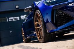 JR Wheels JR44 Bronze alloy wheel mounted on car in an atmospheric setting