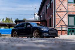 JR Wheels JR45 Bronze alloy wheel mounted on car in an atmospheric setting