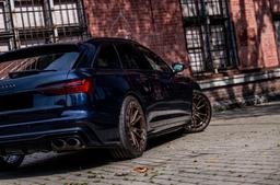 JR Wheels JR45 Bronze alloy wheel mounted on car in an atmospheric setting