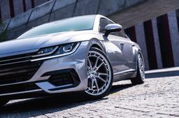 JR Wheels JR45 Silver alloy wheel mounted on car in an atmospheric setting