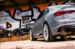 JR Wheels JR46 Silver alloy wheel mounted on car in an atmospheric setting