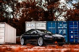 JR Wheels JR46 Silver alloy wheel mounted on car in an atmospheric setting