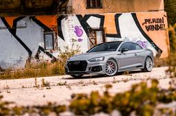 JR Wheels JR46 Silver alloy wheel mounted on car in an atmospheric setting