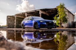 JR Wheels JR46 Black alloy wheel mounted on car in an atmospheric setting