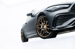 JR Wheels JR46 Bronze alloy wheel mounted on car in an atmospheric setting