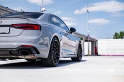 JR Wheels JR46 Black alloy wheel mounted on car in an atmospheric setting