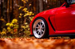 JR Wheels JR47 Silver alloy wheel mounted on car in an atmospheric setting