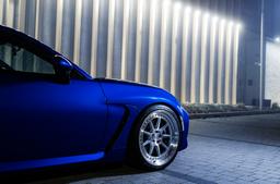 JR Wheels JR47 Silver alloy wheel mounted on car in an atmospheric setting