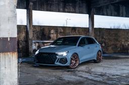 JR Wheels JR50 Bronze alloy wheel mounted on car in an atmospheric setting