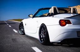 JR Wheels JR5 Grey alloy wheel mounted on car in an atmospheric setting