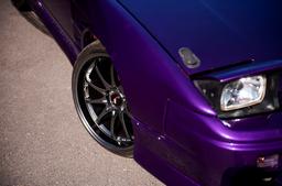 JR Wheels JR5 Grey alloy wheel mounted on car in an atmospheric setting