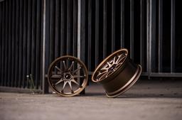 JR Wheels JR5 Bronze alloy wheel mounted on car in an atmospheric setting