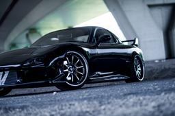 JR Wheels JR5 Grey alloy wheel mounted on car in an atmospheric setting