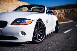 JR Wheels JR5 Grey alloy wheel mounted on car in an atmospheric setting