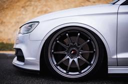 JR Wheels JR5 Grey alloy wheel mounted on car in an atmospheric setting