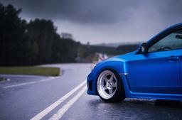 JR Wheels JR6 Silver alloy wheel mounted on car in an atmospheric setting