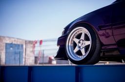 JR Wheels JR6 Silver alloy wheel mounted on car in an atmospheric setting