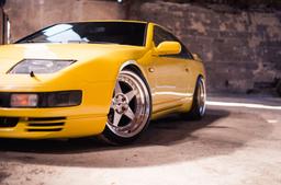 JR Wheels JR6 Silver alloy wheel mounted on car in an atmospheric setting