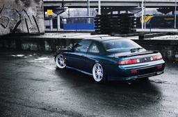 JR Wheels JR7 Silver alloy wheel mounted on car in an atmospheric setting