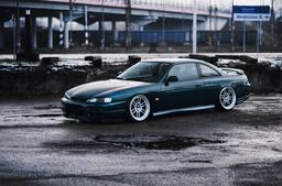 JR Wheels JR7 Silver alloy wheel mounted on car in an atmospheric setting