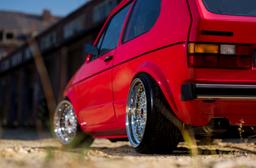 JR Wheels JR9 Silver alloy wheel mounted on car in an atmospheric setting