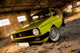 JR Wheels JR9 Silver alloy wheel mounted on car in an atmospheric setting