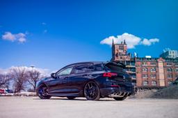 JR Wheels SL-01 Black alloy wheel mounted on car in an atmospheric setting