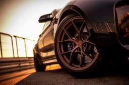 JR Wheels SL-01 Bronze alloy wheel mounted on car in an atmospheric setting