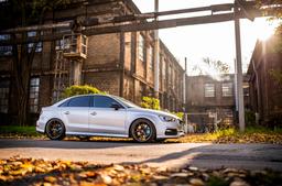 JR Wheels SL-01 Bronze alloy wheel mounted on car in an atmospheric setting