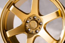 JR Wheels SL-03 Gold alloy wheel mounted on car in an atmospheric setting
