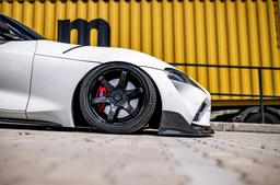 JR Wheels SL-03 Black alloy wheel mounted on car in an atmospheric setting