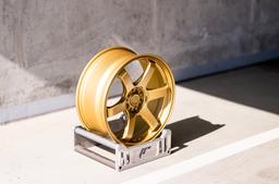 JR Wheels SL-03 Gold alloy wheel mounted on car in an atmospheric setting