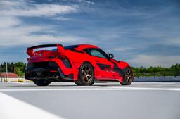 JR Wheels SL-03 Bronze alloy wheel mounted on car in an atmospheric setting