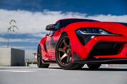 JR Wheels SL-03 Bronze alloy wheel mounted on car in an atmospheric setting