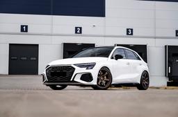 JR Wheels SL-03 Bronze alloy wheel mounted on car in an atmospheric setting